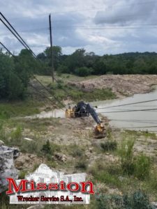 Stuck in the mud: excavator needs construction equipment towing in Texas